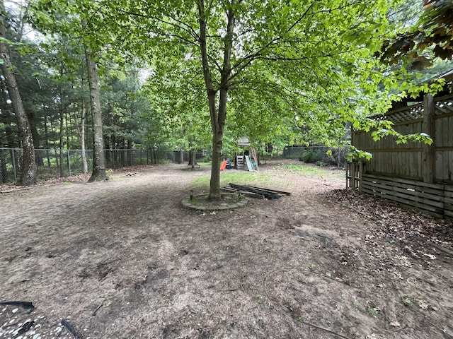 6530 Blue Lake Rd, Twin Lake, MI 49457 - fenced backyard featuring a playground