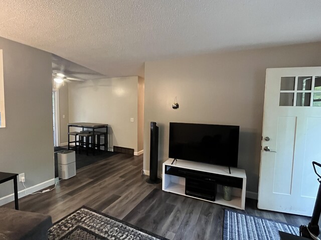 6530 Blue Lake Rd, Twin Lake, MI 49457 - living room with wood finished floors, a ceiling fan, baseboards, and a textured ceiling