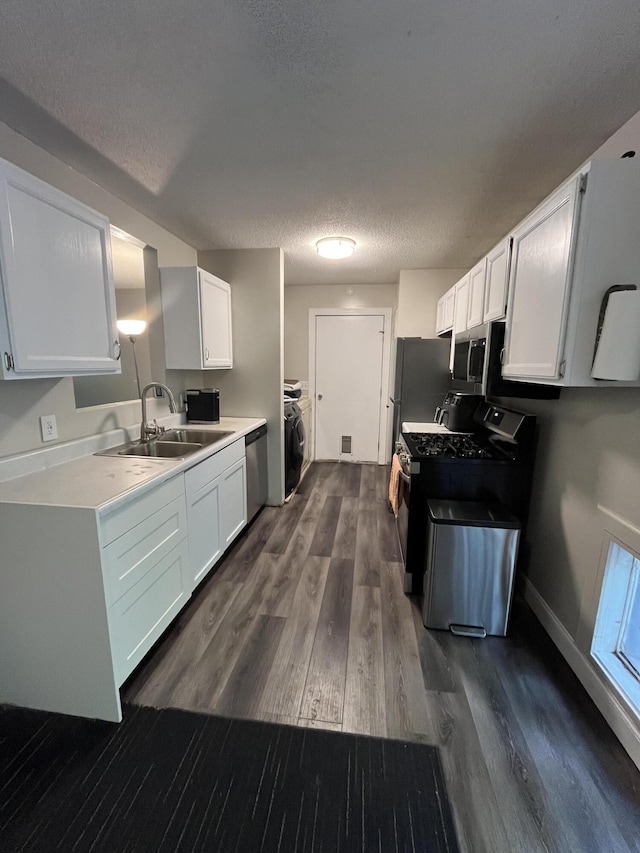 6530 Blue Lake Rd, Twin Lake, MI 49457 - kitchen featuring appliances with stainless steel finishes, a sink, white cabinetry, dark wood finished floors, and a textured ceiling