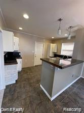 41 Maple St, River Rouge, MI 48218 - kitchen with dark countertops, white cabinetry, recessed lighting, and a peninsula