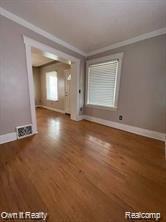 41 Maple St, River Rouge, MI 48218 - unfurnished living room with ornamental molding, wood finished floors, and baseboards