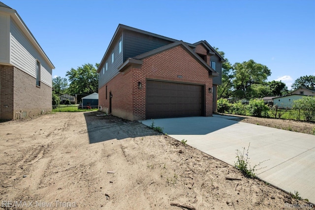 2921 Walsh Dr, Rochester Hills, MI 48309 - view of home's exterior with concrete driveway, brick siding, and a garage