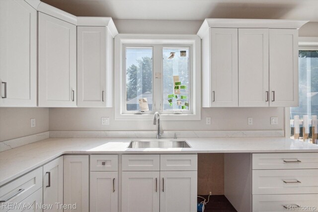 2921 Walsh Dr, Rochester Hills, MI 48309 - kitchen featuring a sink, white cabinetry, and light stone countertops