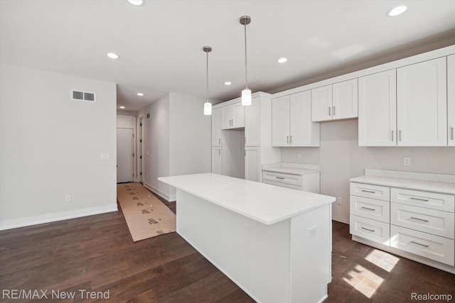2921 Walsh Dr, Rochester Hills, MI 48309 - kitchen featuring recessed lighting, white cabinetry, dark wood-style floors, a kitchen island, and hanging light fixtures