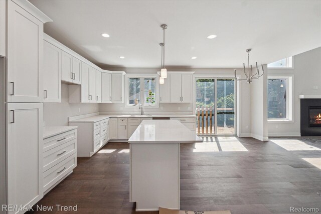 2921 Walsh Dr, Rochester Hills, MI 48309 - kitchen with a sink, dark wood finished floors, recessed lighting, white cabinets, and a kitchen island