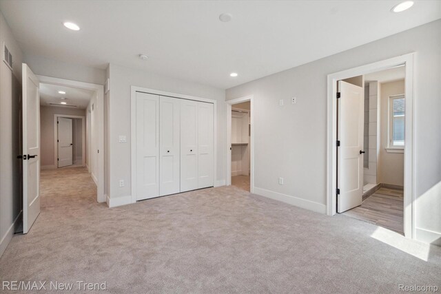 2921 Walsh Dr, Rochester Hills, MI 48309 - unfurnished bedroom with light carpet, recessed lighting, baseboards, a closet, and ensuite bath