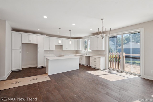 2921 Walsh Dr, Rochester Hills, MI 48309 - kitchen with a kitchen island, recessed lighting, white cabinets, dark wood-style flooring, and pendant lighting