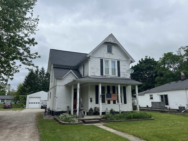 760 W Michigan Ave, Adrian, MI 49221 - victorian home with covered porch, an outbuilding, a garage, a front lawn, and roof with shingles