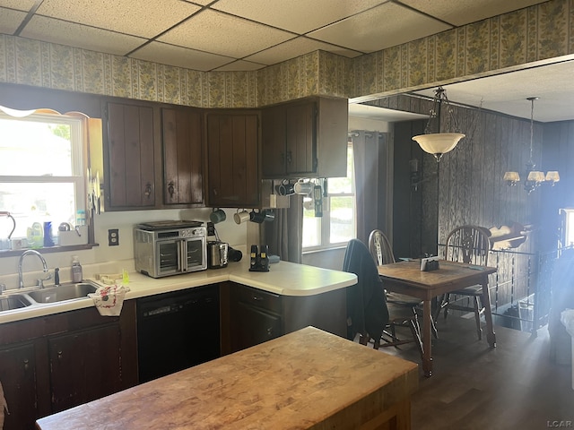 760 W Michigan Ave, Adrian, MI 49221 - kitchen featuring black dishwasher, a sink, light countertops, dark brown cabinetry, and wallpapered walls