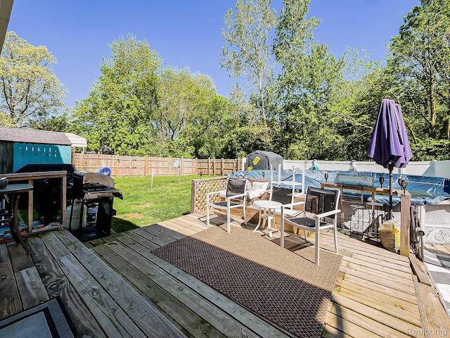 1468 Ruby Ave, Rochester Hills, MI 48309 - deck featuring area for grilling, view of wooded area, outdoor dining area, and a shed