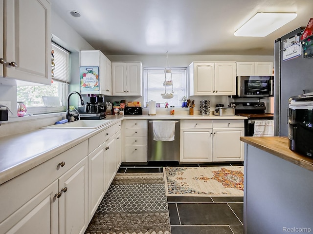 1468 Ruby Ave, Rochester Hills, MI 48309 - kitchen with stainless steel appliances, a sink, and white cabinetry