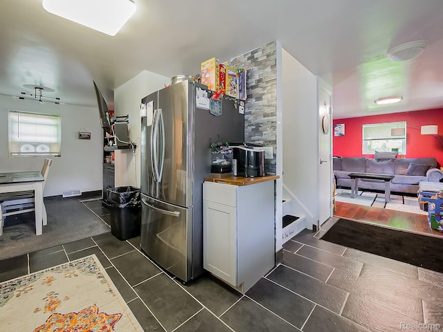 1468 Ruby Ave, Rochester Hills, MI 48309 - kitchen featuring wood counters, freestanding refrigerator, dark tile patterned floors, and white cabinets