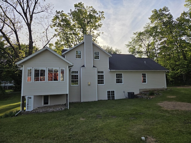6541 S 6th St, Kalamazoo, MI 49008 - rear view of property with a chimney and a yard