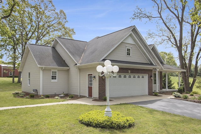 6541 S 6th St, Kalamazoo, MI 49008 - view of front facade featuring driveway, a garage, a front yard, and a shingled roof