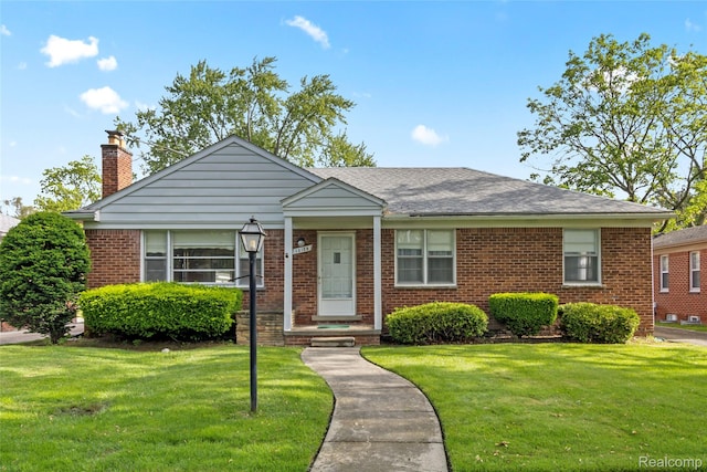 13128 Talbot Ave, Huntington Woods, MI 48070 - view of front of house with brick siding, a front lawn, a chimney, and a shingled roof
