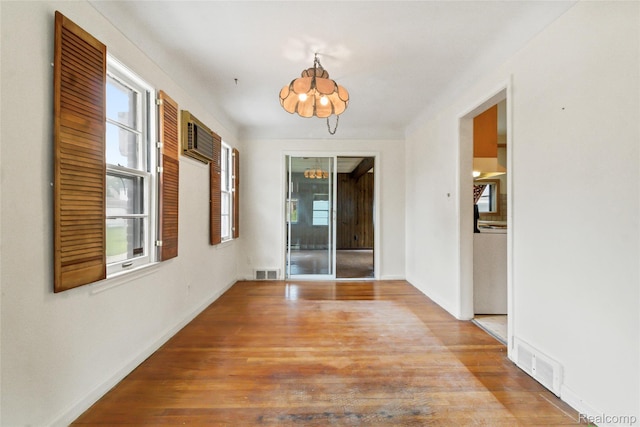 13128 Talbot Ave, Huntington Woods, MI 48070 - hallway featuring a chandelier, plenty of natural light, wood finished floors, and baseboards