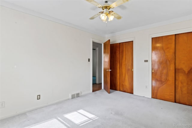 13128 Talbot Ave, Huntington Woods, MI 48070 - unfurnished bedroom with two closets, carpet floors, ceiling fan, and baseboards