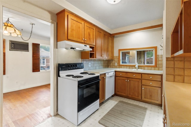 13128 Talbot Ave, Huntington Woods, MI 48070 - kitchen featuring white appliances, under cabinet range hood, brown cabinetry, and light countertops