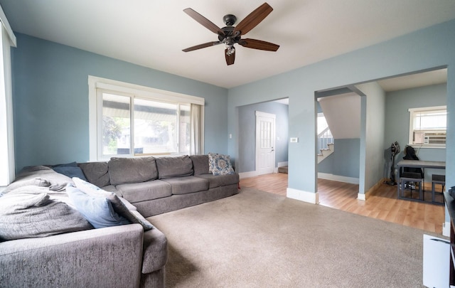 13 Rena St SW, Grand Rapids, MI 49507 - living area featuring ceiling fan, stairs, light carpet, baseboards, and light wood-type flooring