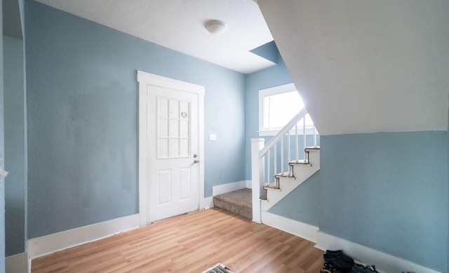13 Rena St SW, Grand Rapids, MI 49507 - foyer entrance featuring wood finished floors, stairs, and baseboards