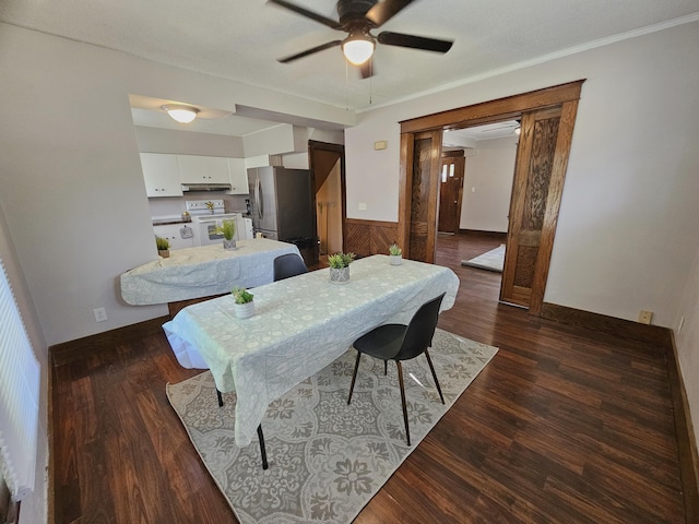 1114 E Michigan Ave, Albion, MI 49224 - dining space featuring a ceiling fan, dark wood-type flooring, wainscoting, and ornamental molding