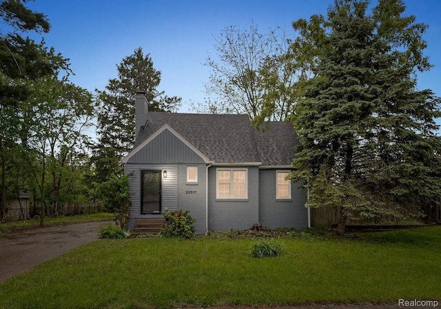 28517 Aberdeen St, Southfield, MI 48076 - view of front of house featuring a chimney, a shingled roof, and board and batten siding
