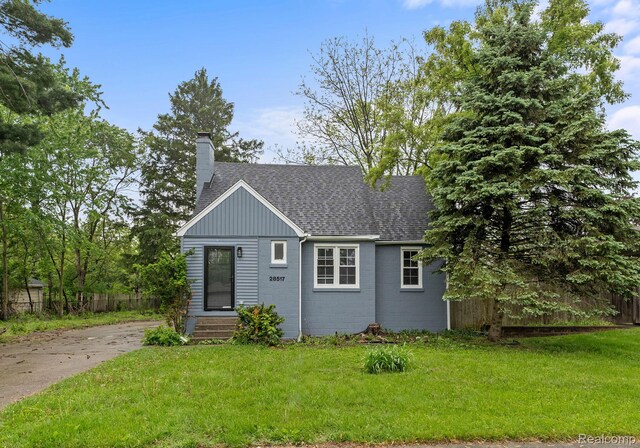 28517 Aberdeen St, Southfield, MI 48076 - view of front of house featuring a chimney, roof with shingles, and driveway