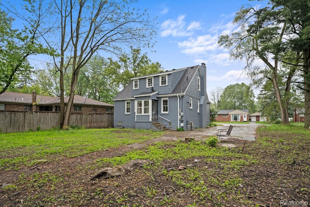 28517 Aberdeen St, Southfield, MI 48076 - back of house with a chimney, entry steps, and roof with shingles
