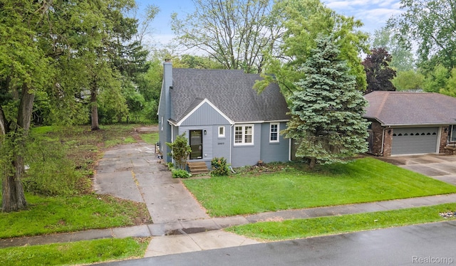 28517 Aberdeen St, Southfield, MI 48076 - view of front of house with a chimney, driveway, a front yard, a shingled roof, and an attached garage