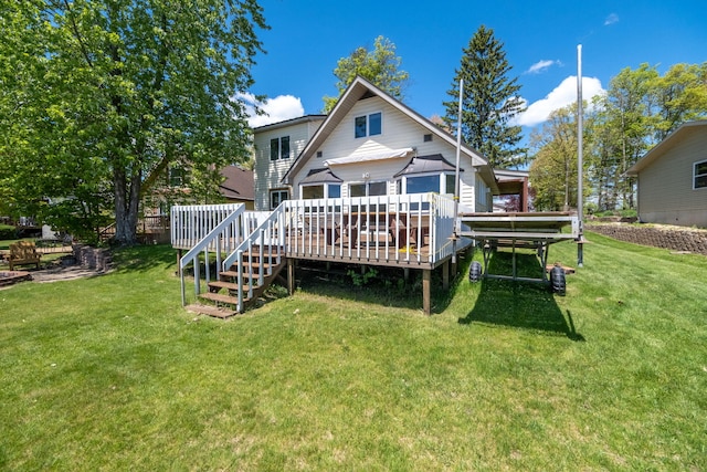 7945 W Royal Rd, Canadian Lakes, MI 49346 - back of property with a wooden deck and a yard