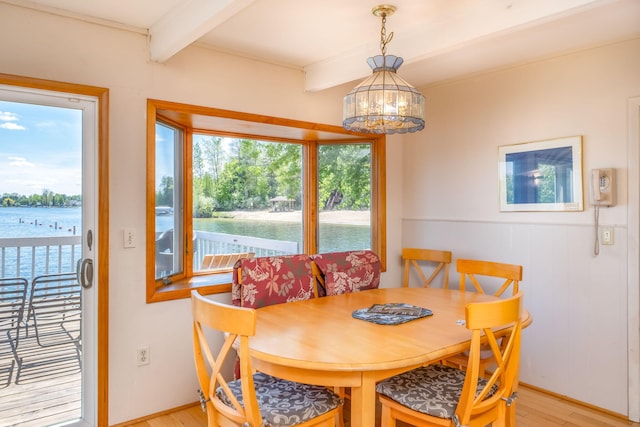 7945 W Royal Rd, Canadian Lakes, MI 49346 - dining area with beam ceiling, light wood-style floors, healthy amount of natural light, and a water view