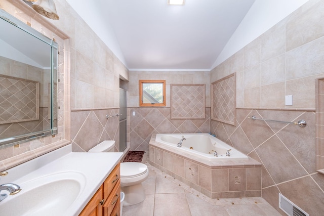 7945 W Royal Rd, Canadian Lakes, MI 49346 - full bathroom featuring tile walls, a whirlpool tub, tile patterned flooring, vaulted ceiling, and toilet