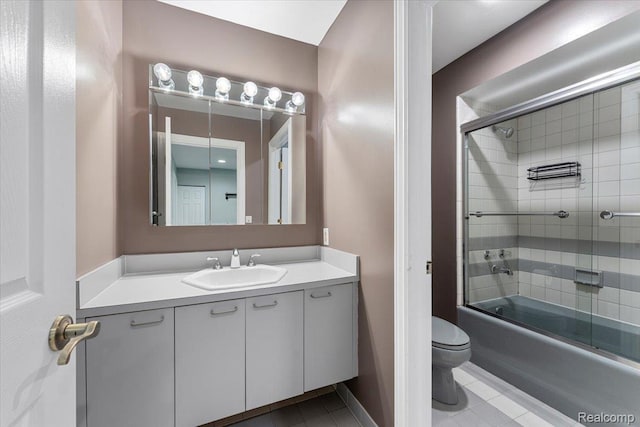 10161 N Loma Cir, Grosse Ile, MI 48138 - bathroom featuring tile patterned floors, vanity, toilet, and bath / shower combo with glass door