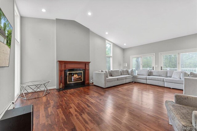 10161 N Loma Cir, Grosse Ile, MI 48138 - living area featuring lofted ceiling, a fireplace with flush hearth, dark wood finished floors, and recessed lighting