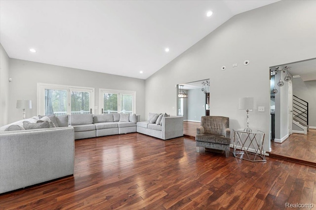 10161 N Loma Cir, Grosse Ile, MI 48138 - living area with stairway, wood finished floors, high vaulted ceiling, recessed lighting, and baseboards