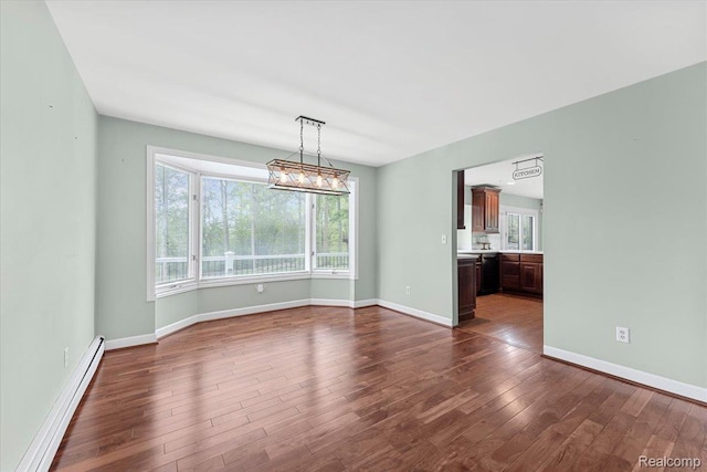 10161 N Loma Cir, Grosse Ile, MI 48138 - empty room featuring a baseboard radiator, dark wood-style flooring, and baseboards