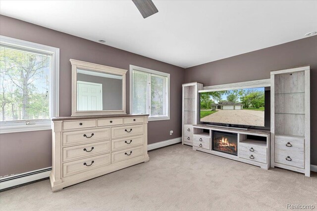 10161 N Loma Cir, Grosse Ile, MI 48138 - unfurnished bedroom with a baseboard radiator, multiple windows, and light colored carpet