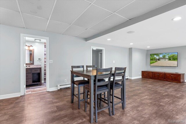 10161 N Loma Cir, Grosse Ile, MI 48138 - dining room with baseboards, baseboard heating, a drop ceiling, recessed lighting, and dark wood-style floors