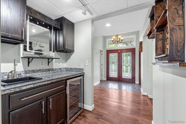 10161 N Loma Cir, Grosse Ile, MI 48138 - kitchen with beverage cooler, a sink, french doors, dark wood-style flooring, and dark brown cabinets