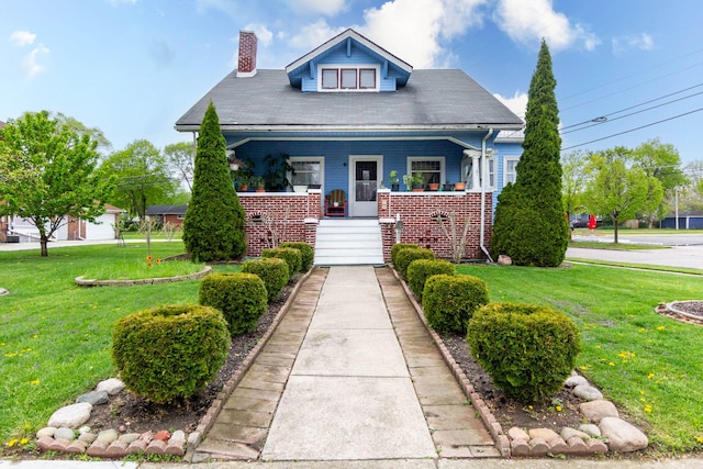 323 Northbound Gratiot Ave, Mount Clemens, MI 48043 - bungalow featuring a front lawn, a chimney, covered porch, and stairs