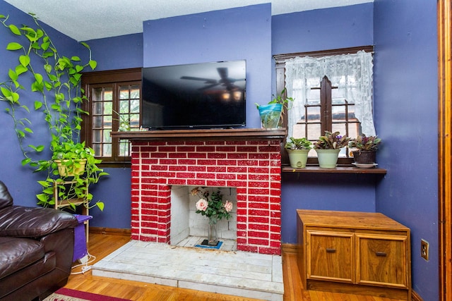 323 Northbound Gratiot Ave, Mount Clemens, MI 48043 - living area featuring a fireplace, wood finished floors, and baseboards