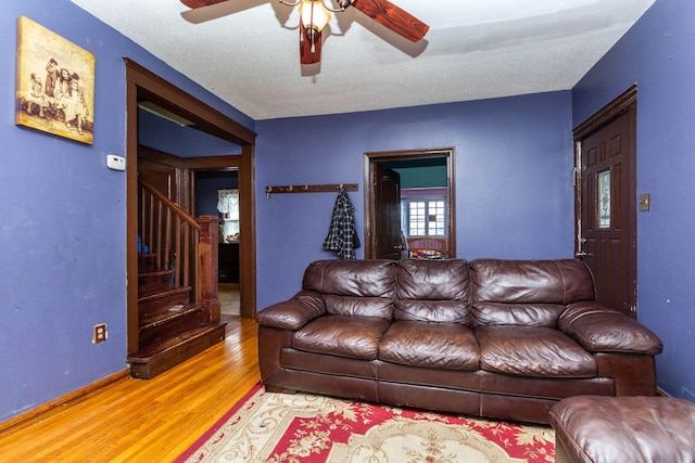 323 Northbound Gratiot Ave, Mount Clemens, MI 48043 - living room featuring wood finished floors, a ceiling fan, stairs, a textured ceiling, and baseboards