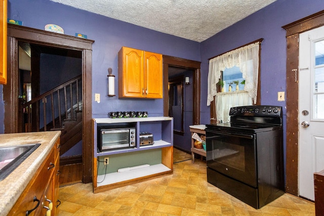 323 Northbound Gratiot Ave, Mount Clemens, MI 48043 - kitchen featuring black range with electric stovetop, light countertops, brown cabinetry, and a sink
