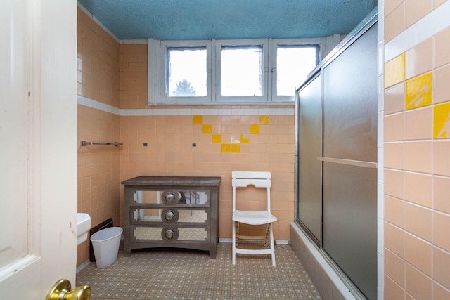 323 Northbound Gratiot Ave, Mount Clemens, MI 48043 - bathroom featuring tile walls, a shower with door, tile patterned flooring, and plenty of natural light