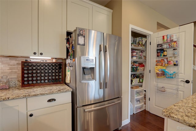 23971 Manistee Ln, Flat Rock, MI 48134 - kitchen featuring stainless steel fridge, decorative backsplash, white cabinetry, dark wood-style flooring, and light stone countertops