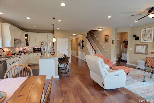 23971 Manistee Ln, Flat Rock, MI 48134 - living room featuring recessed lighting, dark wood-style floors, ceiling fan, baseboards, and stairs