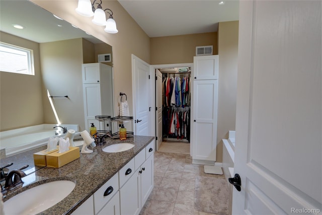 23971 Manistee Ln, Flat Rock, MI 48134 - bathroom with a bath, double vanity, and a walk in closet