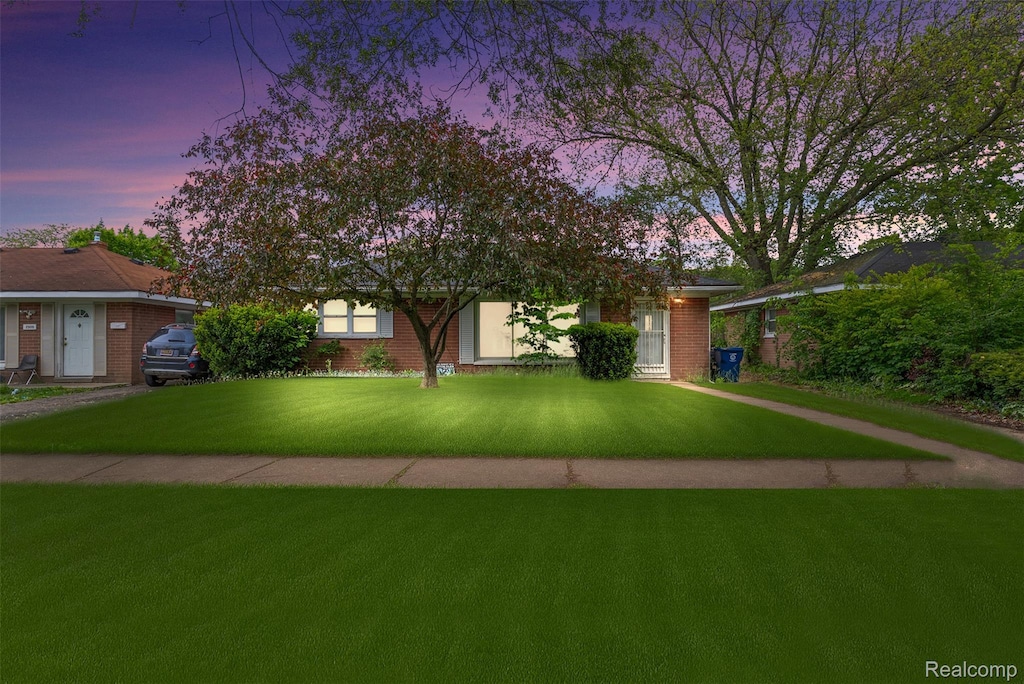 2913 Cheyenne Ave, Flint, MI 48507 - view of property hidden behind natural elements with a lawn and brick siding