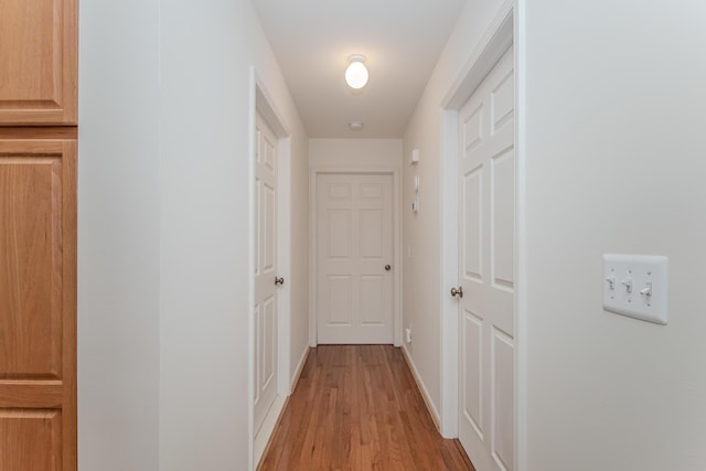 128 Commons Cir, Saline, MI 48176 - hallway featuring light wood-type flooring and baseboards