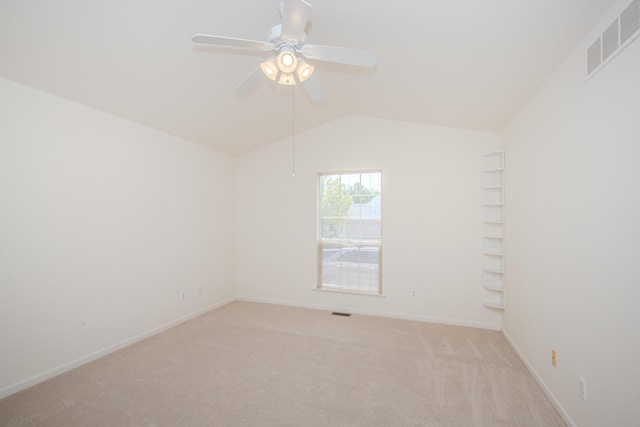 128 Commons Cir, Saline, MI 48176 - spare room featuring light carpet, ceiling fan, lofted ceiling, and baseboards